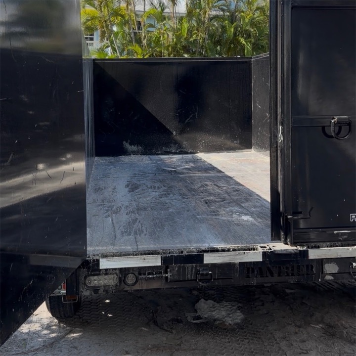 Rear doors swung open on the trailer's clean, empty bed